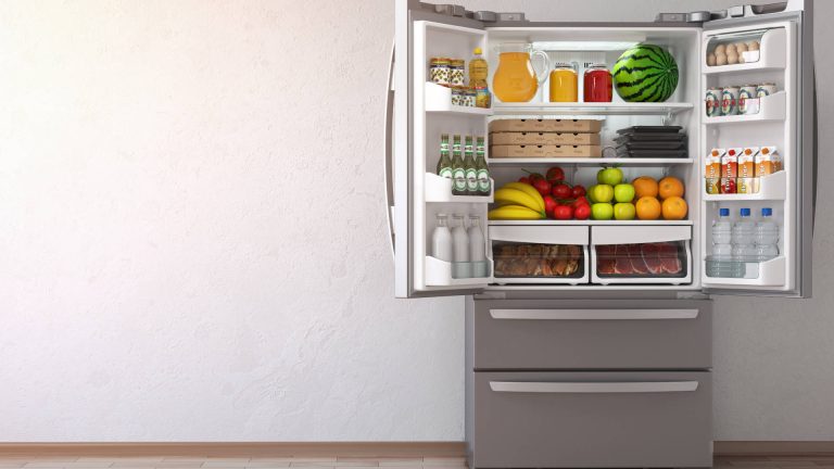French-door refrigerator with both doors open and stocked with food