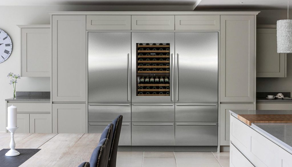 Built-in Sub-Zero refrigerator and freezer columns with a wine storage unit in a modern kitchen