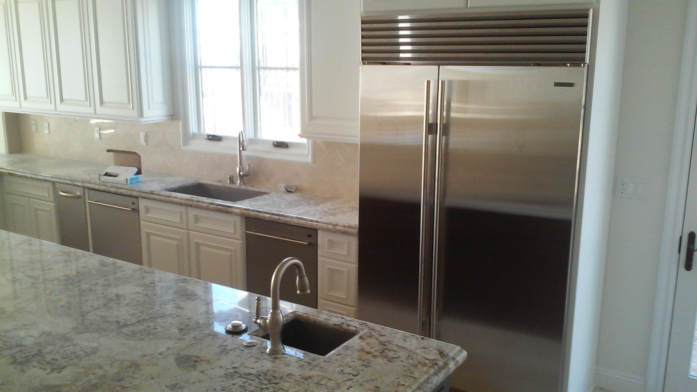 Sub-Zero Repair Service 6 Built-in stainless side-by-side refrigerator in a kitchen with granite counters