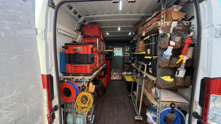 Appliance Repair Edmond, OK 3 Inside a service van: organized tool cases, hoses and diagnostic equipment on shelves