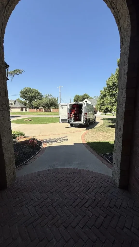 Appliance Repair Edmond, OK 2 Service van parked outside a customer’s home, seen through an arched front entry