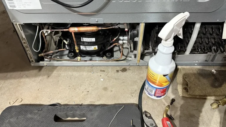 Refrigerator compressor and sealed-system tubing exposed for diagnostic service