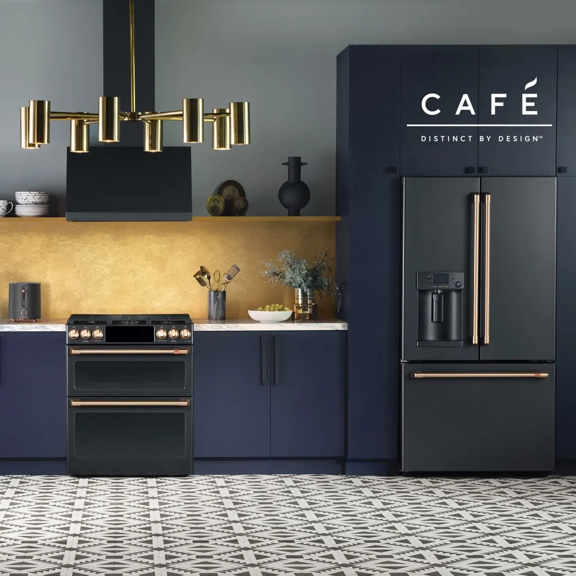 Café range and refrigerator in a navy kitchen.