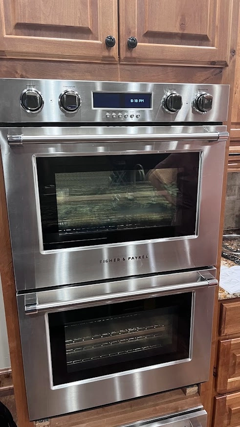 Stainless Fisher and Paykel double wall oven in wood cabinetry.