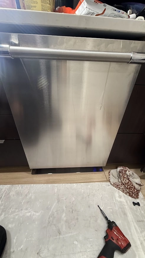 GE Appliance Repair in Edmond & Oklahoma City 7 Stainless GE dishwasher beneath a kitchen counter with tools nearby.