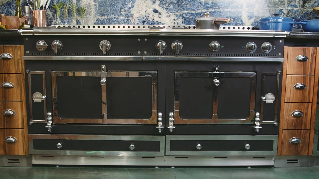 Black La Cornue range with multiple oven doors and metal trim.
