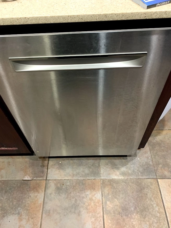 Stainless Maytag dishwasher installed beneath a countertop.