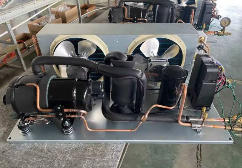 Split refrigeration unit with two fans, compressor, and copper tubing.