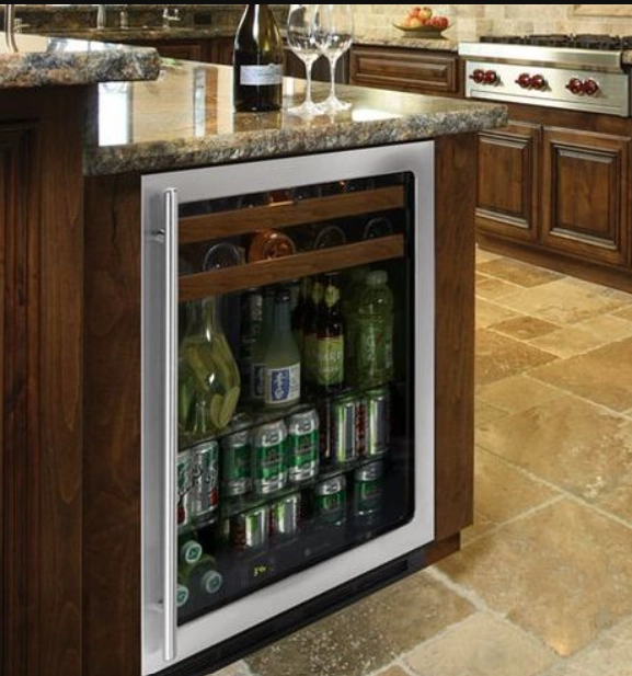 U Line beverage refrigerator stocked with drinks beneath a kitchen counter.