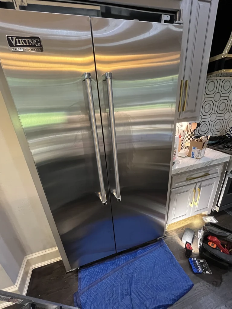 Stainless Viking side by side refrigerator with dispenser.