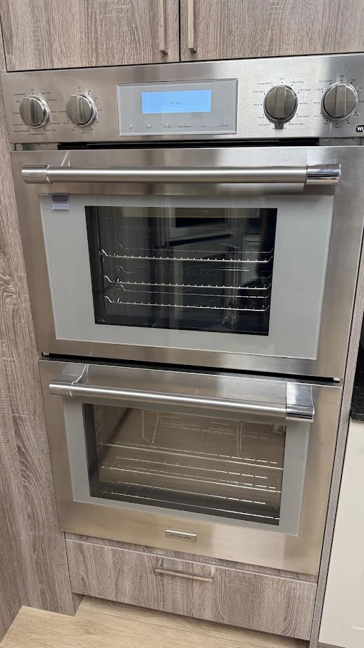Stainless double wall oven with digital controls in cabinetry.
