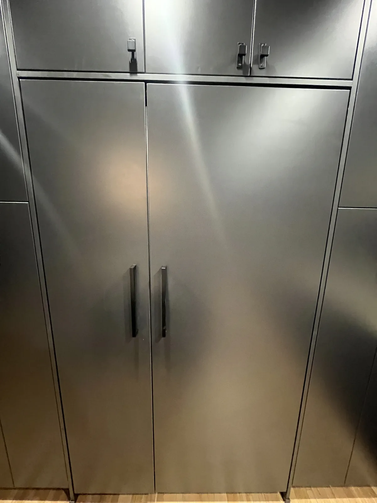 Built-in column refrigerator and freezer with dark metal panels and black handles