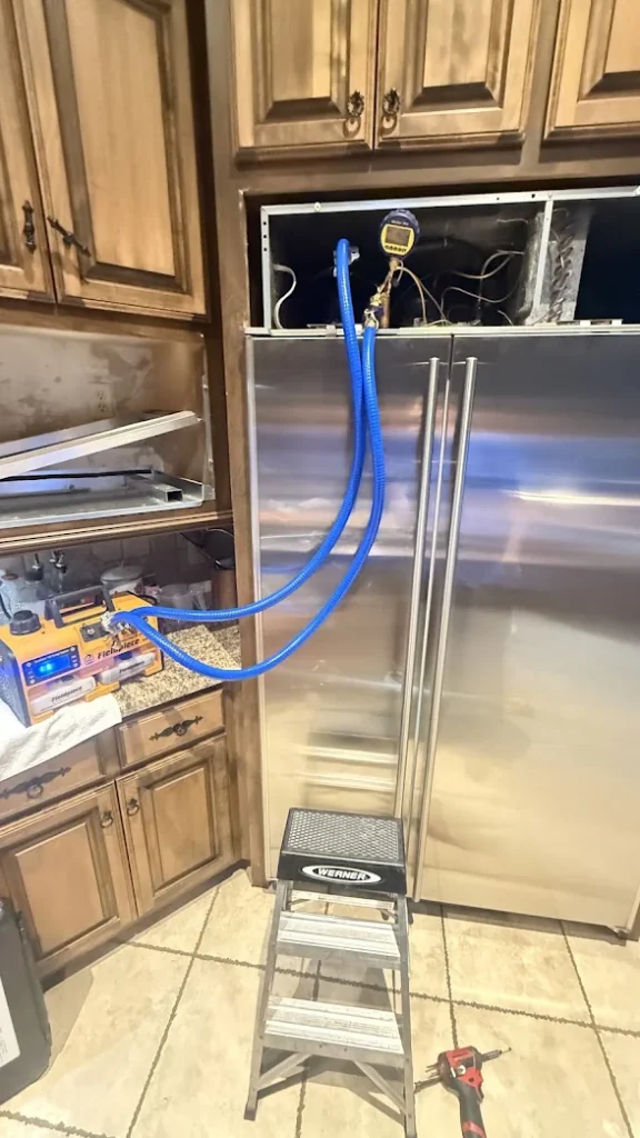 Appliance Repair Services in Edmond & OKC 11 Built-in refrigerator with blue diagnostic hoses and service gauges connected.