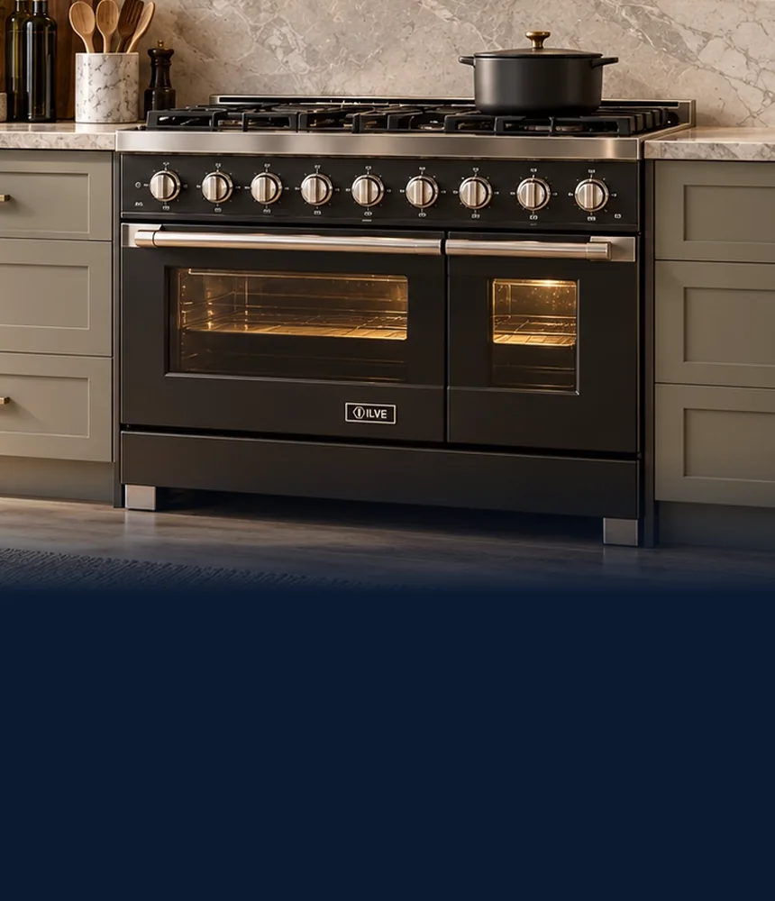 Black ILVE range with brass knobs in a kitchen with a marble backsplash