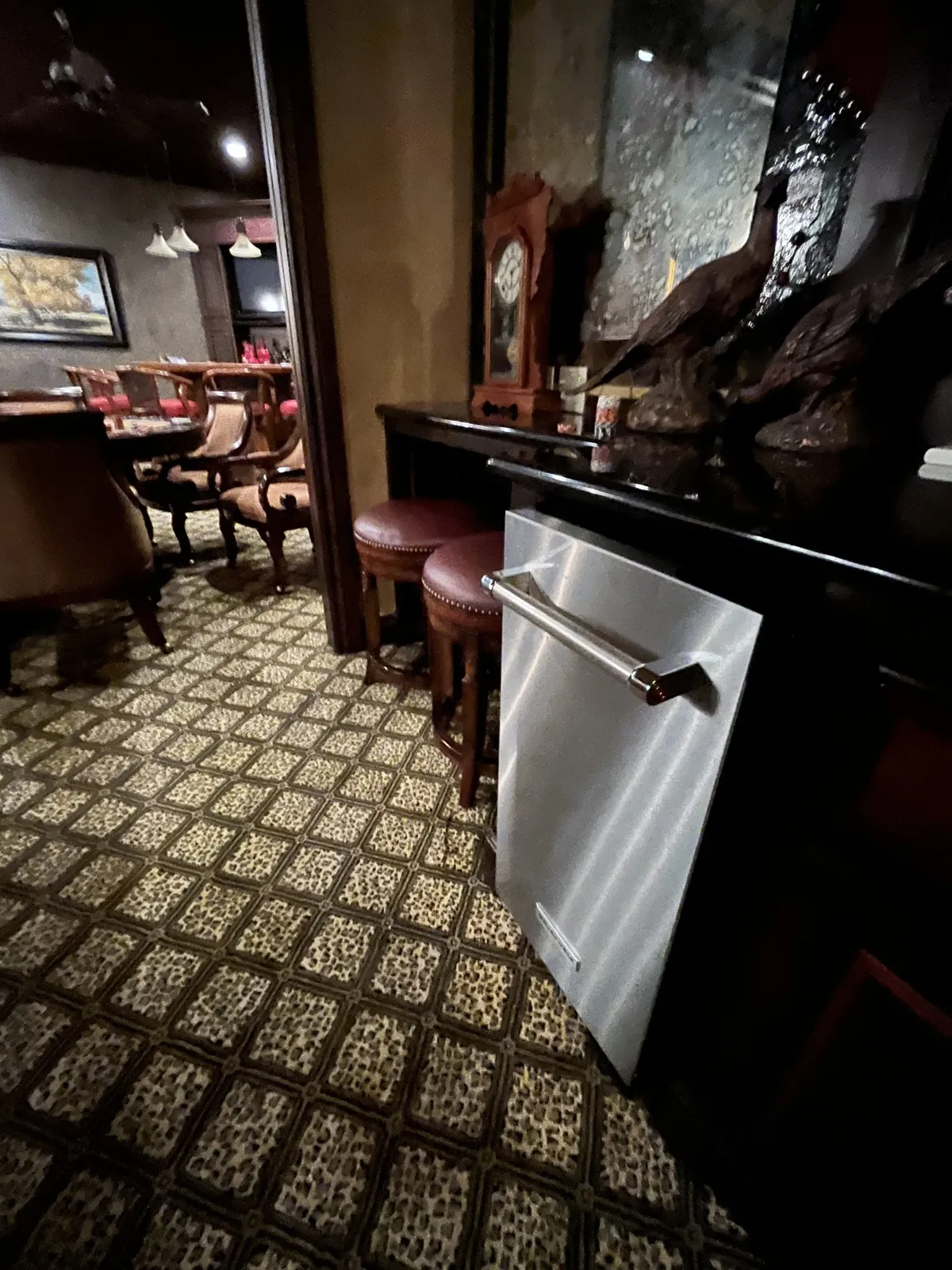 Stainless KitchenAid undercounter ice machine at a home bar