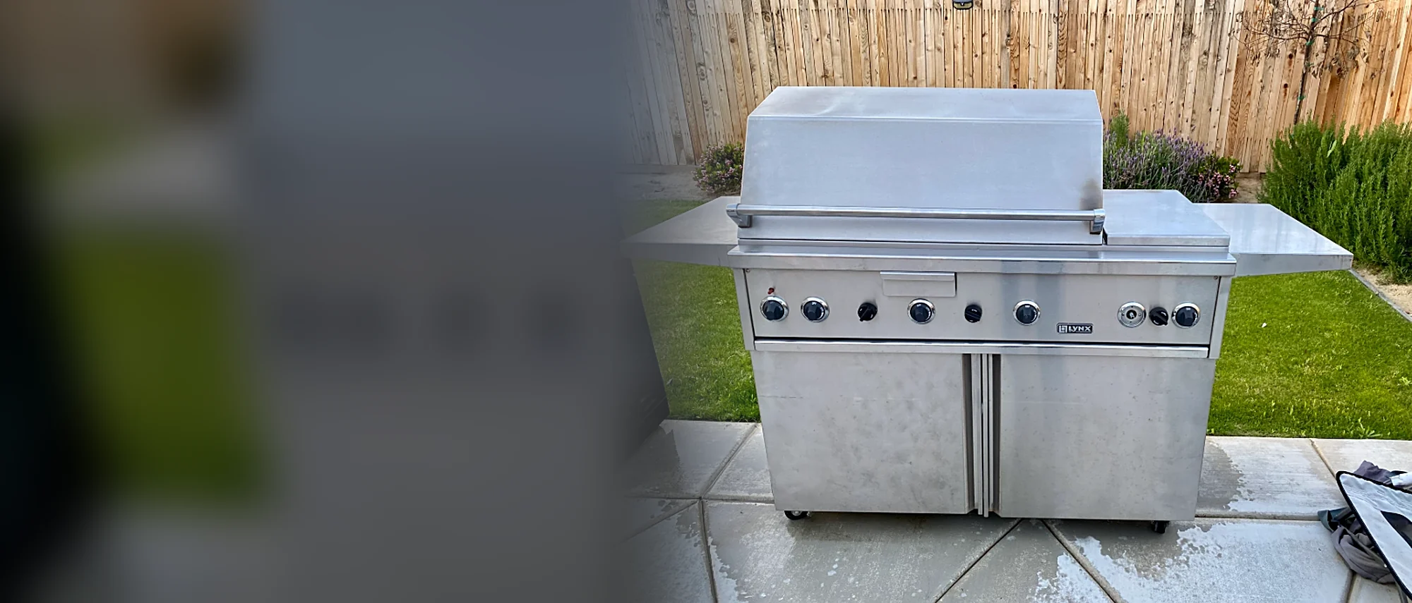 Stainless Lynx gas grill on a cart in a backyard