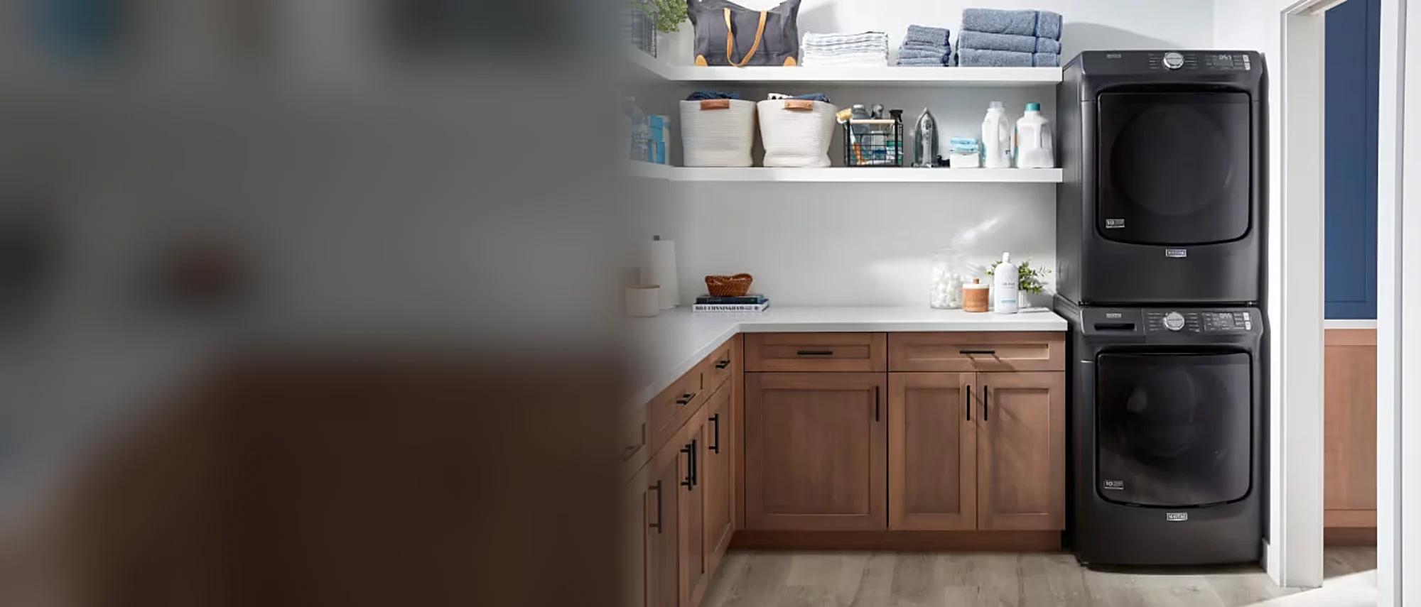 Black Maytag stacked washer and dryer in a laundry room