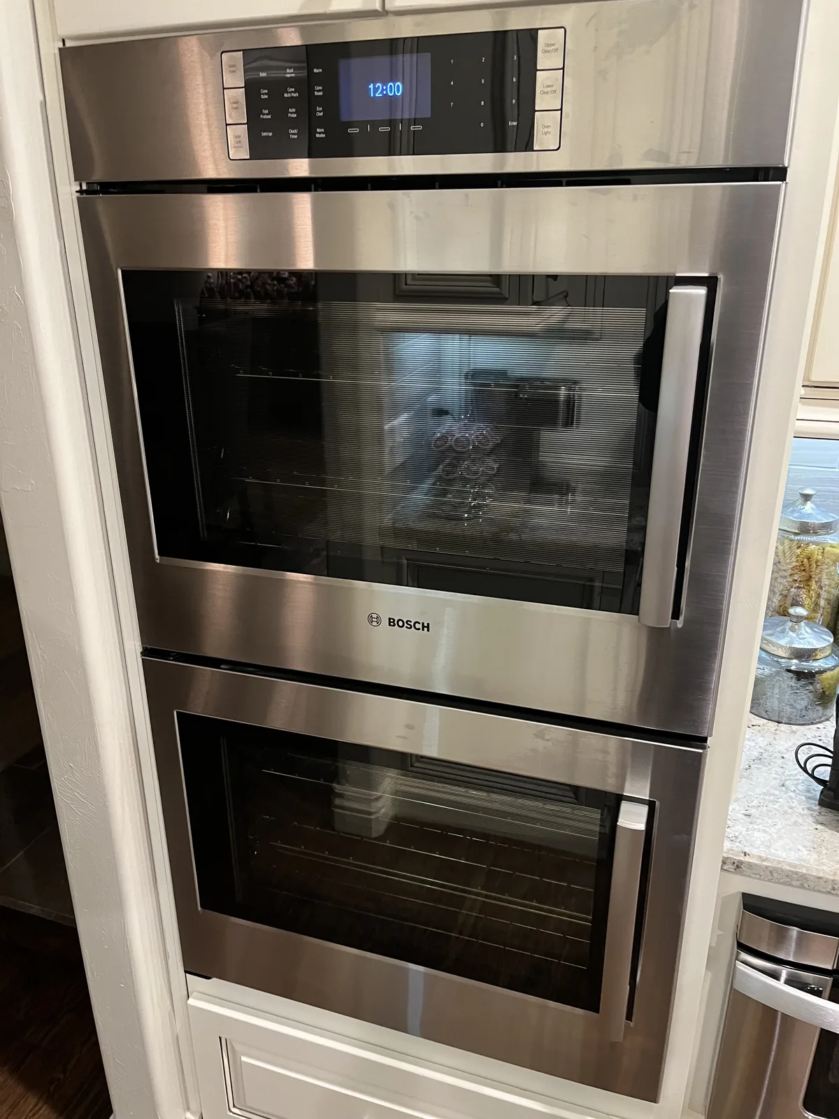 Stainless steel Bosch double wall oven installed in kitchen cabinetry