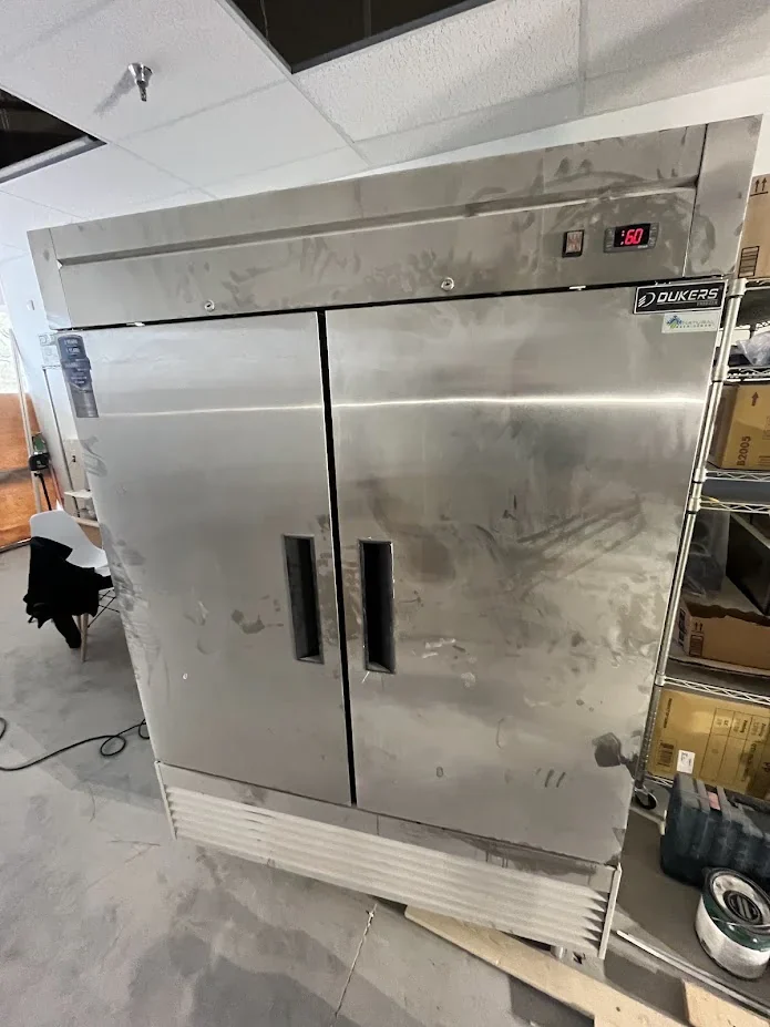 Stainless steel commercial refrigerator in a business setting