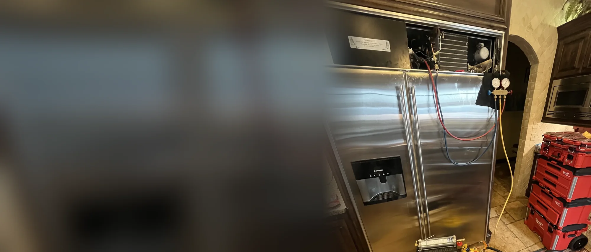 JennAir side-by-side refrigerator with gauges connected for sealed-system service