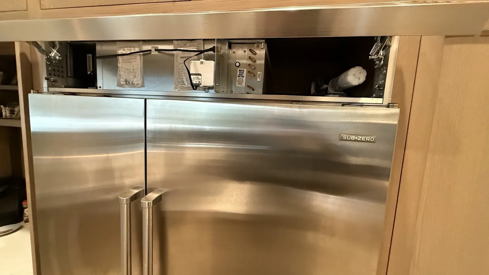Sub-Zero built-in refrigerator with the upper service compartment open