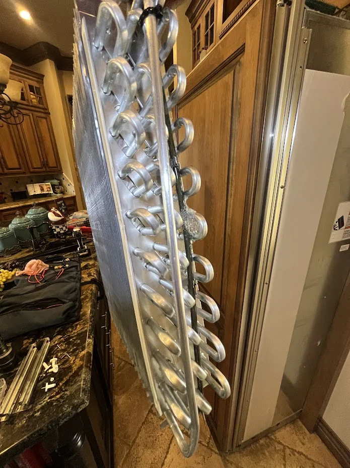 Refrigeration evaporator coil removed from a built-in refrigerator during a repair