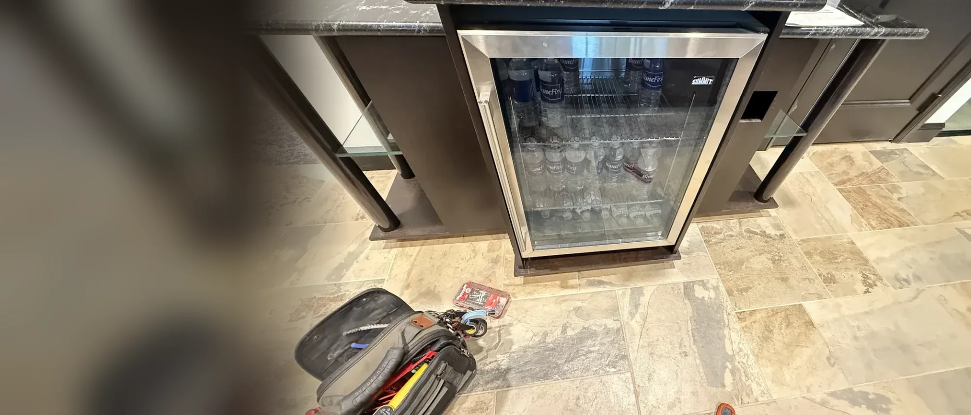 Undercounter wine cooler with glass door in a kitchen island