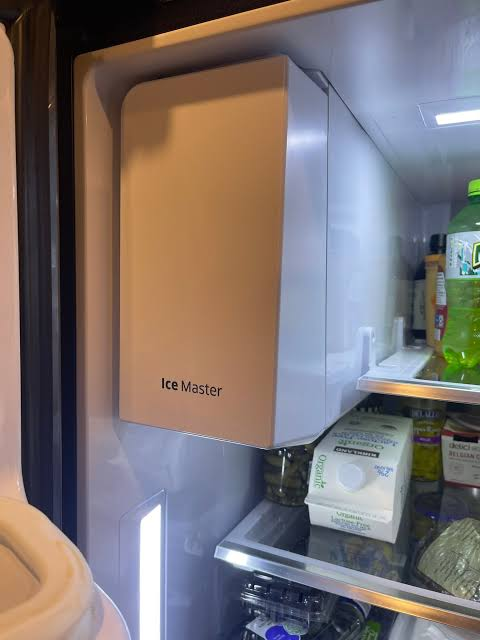 Ice Maker & Ice Machine Repair in Edmond & Oklahoma City 6 Samsung Ice Master ice maker inside an open refrigerator beside the food shelves