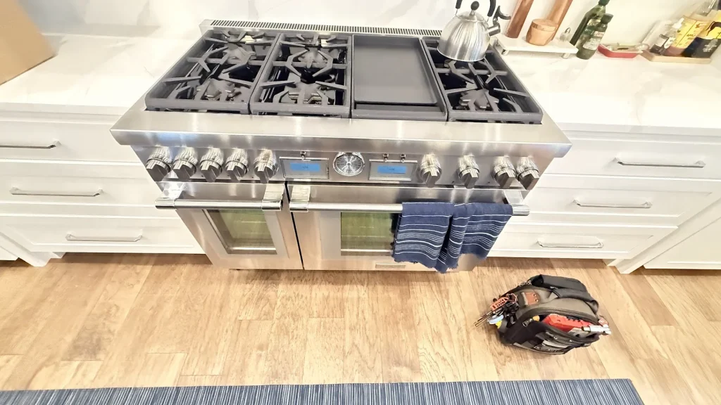 Arcadia Appliance Repair 5 Stainless professional double-oven range in a bright white kitchen.