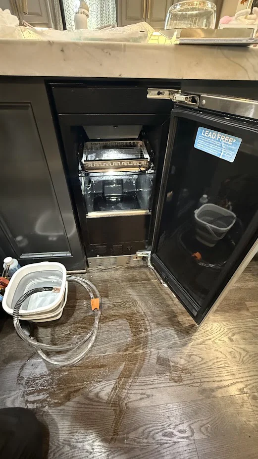Ice Maker & Ice Machine Repair in Edmond & Oklahoma City 5 Undercounter ice machine pulled from cabinetry with tubing and tools visible.