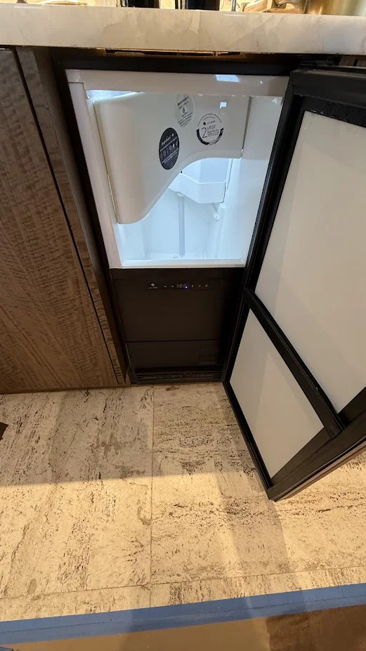 Ice Maker & Ice Machine Repair in Edmond & Oklahoma City 10 Open undercounter ice machine showing its interior in a kitchen.