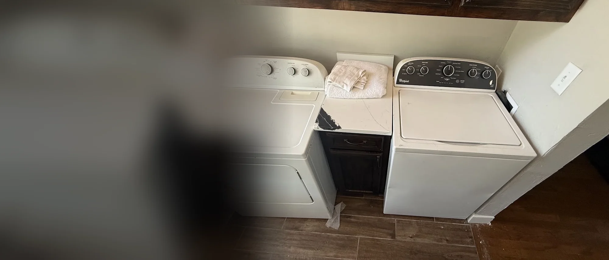 Whirlpool top-load washer and dryer in a laundry room